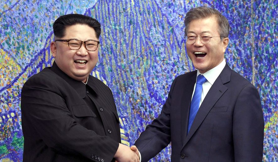 FILE- In this April 27, 2018, file photo, North Korean leader Kim Jong Un, left, poses with South Korean President Moon Jae-in for a photo inside the Peace House at the border village of Panmunjom in Demilitarized Zone, South Korea. Kim Jong Un will be keeping North Korea watchers busy on New Year’s Day, when he is expected to give his annual speech laying out the country’s top priorities for the year ahead.  Kim has a lot to talk about, like the future of his nukes, what he might want to get out of a second summit with President Trump and what’s next in his peace offensive with the South. (Korea Summit Press Pool via AP. File)