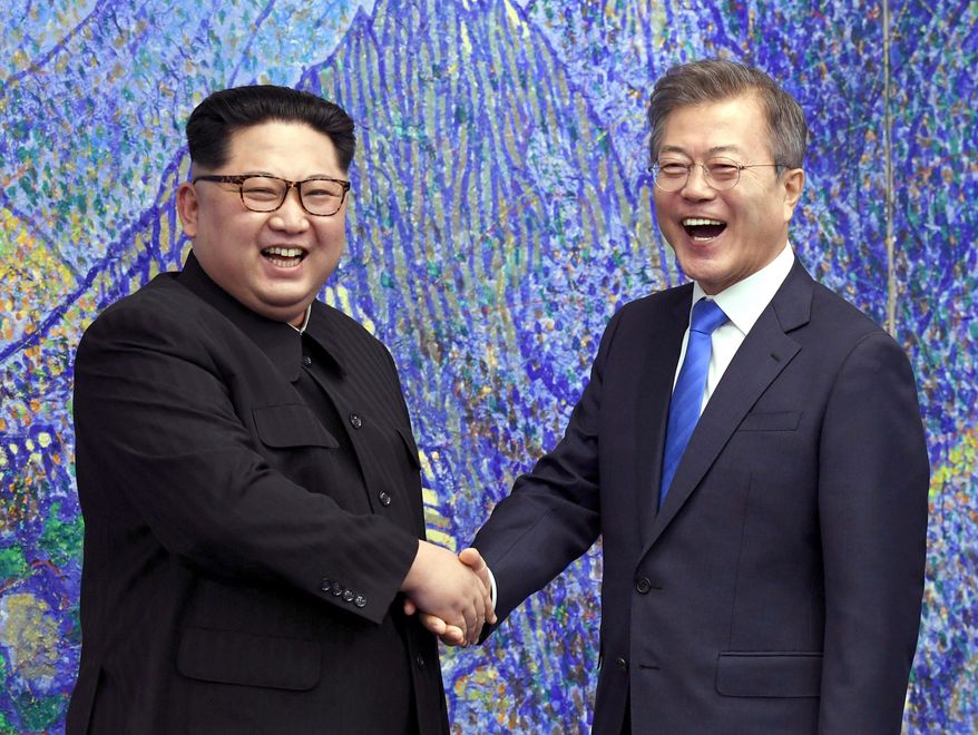 FILE- In this April 27, 2018, file photo, North Korean leader Kim Jong Un, left, poses with South Korean President Moon Jae-in for a photo inside the Peace House at the border village of Panmunjom in Demilitarized Zone, South Korea. Kim Jong Un will be keeping North Korea watchers busy on New Year’s Day, when he is expected to give his annual speech laying out the country’s top priorities for the year ahead.  Kim has a lot to talk about, like the future of his nukes, what he might want to get out of a second summit with President Trump and what’s next in his peace offensive with the South. (Korea Summit Press Pool via AP. File)