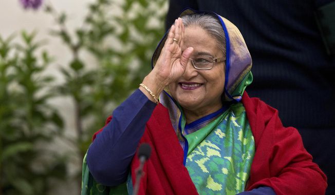 Bangladeshi Prime Minister Sheikh Hasina greets the gathering during an interaction with journalists in Dhaka, Bangladesh, Monday, Dec. 31, 2018. Bangladesh&#x27;s ruling alliance won virtually every parliamentary seat in the country&#x27;s general election, according to official results released Monday, giving Hasina a third straight term despite allegations of intimidation and the opposition disputing the outcome. (AP Photo/Anupam Nath)
