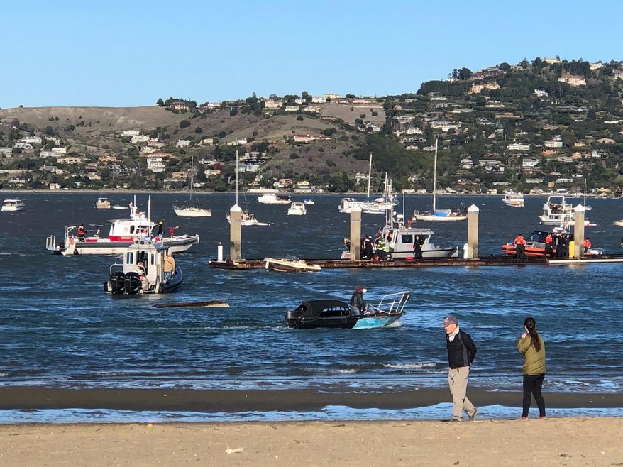 This photo provided by the Southern Marin Fire District shows emergency personnel responding after a small boat capsized in the San Francisco Bay, Monday, Dec. 31, 2018. (Southern Marin Fire District via AP)