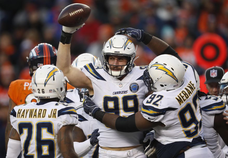 Los Angeles Chargers defensive end Joey Bosa, center, reacts with teammates after recovering a fumble during the second half of an NFL football game against the Denver Broncos, Sunday, Dec. 30, 2018, in Denver. (AP Photo/David Zalubowski)