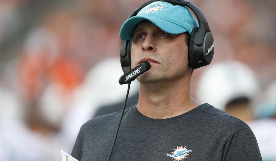 FILE - In this Oct. 7, 2018, file photo Miami Dolphins head coach Adam Gase stand on the sideline during the first half of an NFL football game against the Cincinnati Bengals in Cincinnati. Gase has been fired after three seasons as the Miami Dolphins coach, including a 7-9 finish this year. Gase confirmed his dismissal in a text message Monday, Dec. 31 to The Associated Press. (AP Photo/Gary Landers, File)