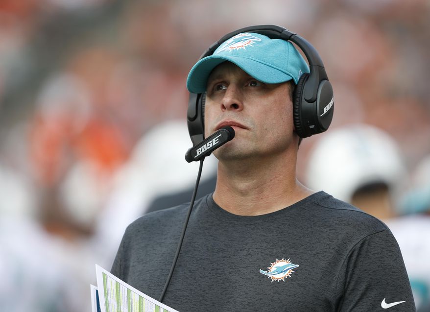 FILE - In this Oct. 7, 2018, file photo Miami Dolphins head coach Adam Gase stand on the sideline during the first half of an NFL football game against the Cincinnati Bengals in Cincinnati. Gase has been fired after three seasons as the Miami Dolphins coach, including a 7-9 finish this year. Gase confirmed his dismissal in a text message Monday, Dec. 31 to The Associated Press. (AP Photo/Gary Landers, File)