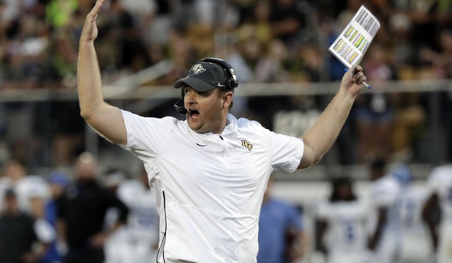 FILE - In this Dec. 1, 2018, file photo, Central Florida head coach Josh Heupel waves his arms during the first half of the American Athletic Conference championship NCAA college football game against Memphis, in Orlando, Fla. No. 7 Central Florida is aiming for a second straight undefeated season and self-proclaimed national championship when they go up against No. 11 LSU in the Fiesta Bowl, Tuesday, Jan. 1, 2019. (AP Photo/John Raoux, File)