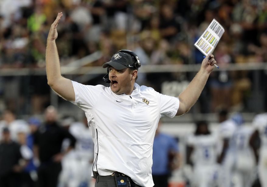 FILE - In this Dec. 1, 2018, file photo, Central Florida head coach Josh Heupel waves his arms during the first half of the American Athletic Conference championship NCAA college football game against Memphis, in Orlando, Fla. No. 7 Central Florida is aiming for a second straight undefeated season and self-proclaimed national championship when they go up against No. 11 LSU in the Fiesta Bowl, Tuesday, Jan. 1, 2019. (AP Photo/John Raoux, File)