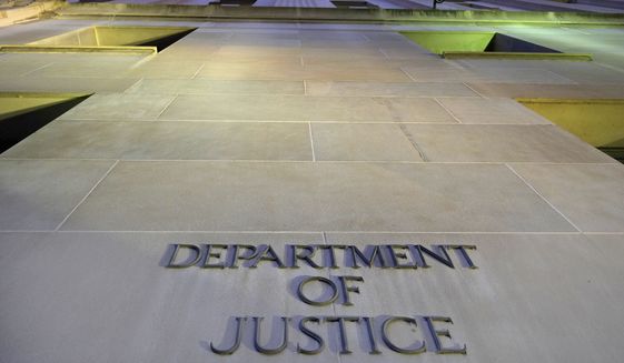 In this May 14, 2013, file photo, the Department of Justice headquarters building in Washington is photographed early in the morning. (Associated Press)