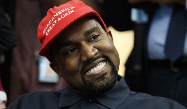 Rapper Kanye West smiles as he listens to a question from a reporter during a meeting in the Oval Office of the White House with President Donald Trump, Thursday, Oct. 11, 2018, in Washington. (AP Photo/Evan Vucci)  ** FILE **