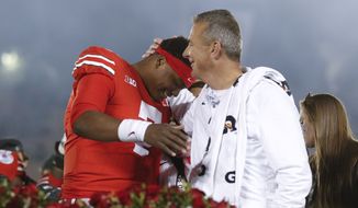 Ohio State coach Urban Meyer, right, celebrates with quarterback Dwayne Haskins after Ohio State&#x27;s 28-23 win over Washington in the Rose Bowl NCAA college football game Tuesday, Jan. 1, 2019, in Pasadena, Calif. (AP Photo/Jae C. Hong)