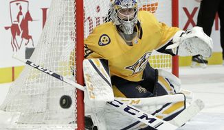 Nashville Predators goaltender Juuse Saros, of Finland, watches the puck during the first period of the team&#39;s NHL hockey game against the Philadelphia Flyers on Tuesday, Jan. 1, 2019, in Nashville, Tenn. (AP Photo/Mark Humphrey)
