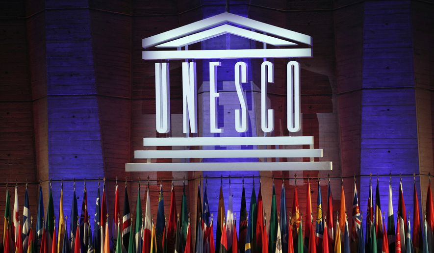 In this Saturday, Nov. 4, 2017, file photo, the logo of the United Nations Educational, Scientific and Cultural Organisation (UNESCO) is seen during the 39th session of the General Conference at the UNESCO headquarters in Paris, France. The United States and Israel have quit the U.N.’s educational, scientific and cultural agency, arguing the organization fosters anti-Israel bias. (AP Photo/Christophe Ena, File)