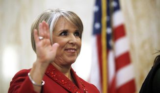 Gov. Michelle Lujan Grisham is sworn in as the 32nd governor of the state of New Mexico on Tuesday, January 1, 2019, at the state Capitol in Santa Fe, New Mexico. (Luis Sánchez Saturno/The New Mexican via AP)
