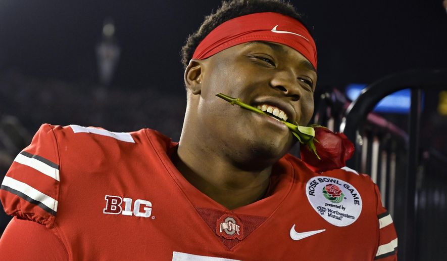 Ohio State quarterback Dwayne Haskins smiles, with a rose between his teeth, after Ohio State defeated Washington 28-23 in the Rose Bowl NCAA college football game Tuesday, Jan. 1, 2019, in Pasadena, Calif. (AP Photo/Mark J. Terrill) ** FILE **