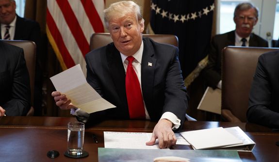President Donald Trump holds up a letter he says is from North Korean leader Kim Jong Un during a cabinet meeting at the White House, Wednesday, Jan. 2, 2019, in Washington. (AP Photo/Evan Vucci)