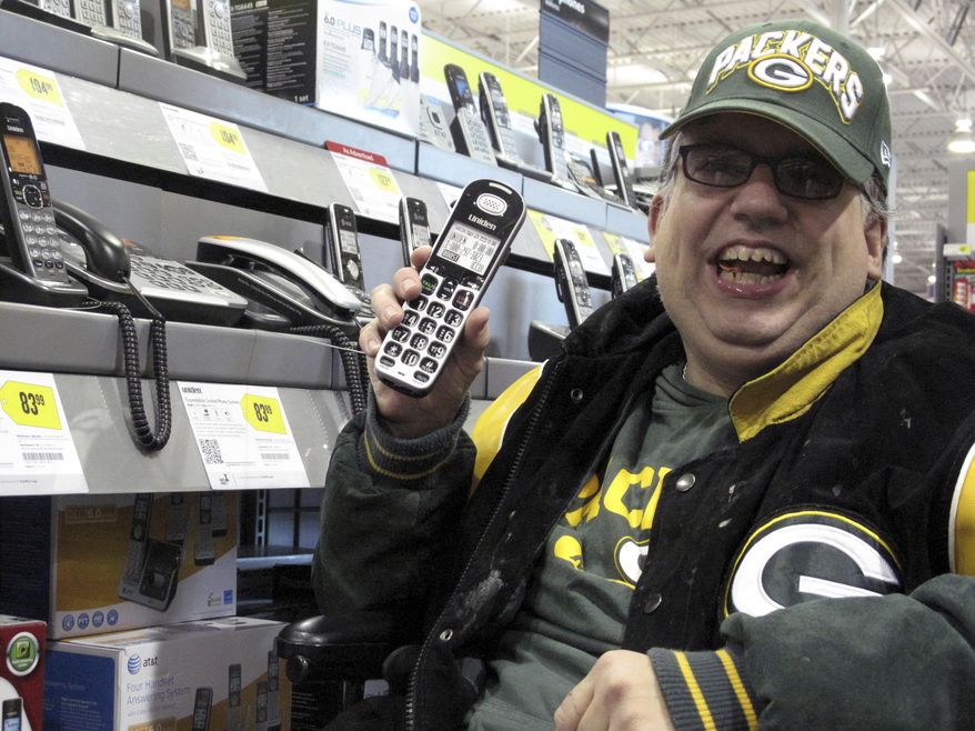 FILE - In this Sept. 17, 2012 file photo, Sean Irvin browses phones at a Best Buy store in Anchorage, Alaska. It was one of the ways Irvin planned to spend his yearly Alaska Permanent Fund dividend. The Alaska Department of Revenue has shut down online applications for Alaska Permanent Fund dividends because of security concerns. The department in an announcement Tuesday, Jan. 1, 2019, said some applicants had inadvertently seen personal information belonging to other applicants who had filed previously. (AP Photo/Rachel D'Oro, File)