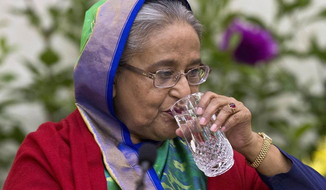 Bangladeshi Prime Minister Sheikh Hasina drinks water during an interaction with journalists in Dhaka, Bangladesh, Monday, Dec. 31, 2018. Bangladesh&#x27;s ruling alliance won virtually every parliamentary seat in the country&#x27;s general election, according to official results released Monday, giving Hasina a third straight term despite allegations of intimidation and the opposition disputing the outcome. (AP Photo/Anupam Nath)