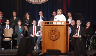 Democratic New Mexico Gov. Michelle Lujan Grisham urges greater state spending on public education during her inaugural address on Tuesday, Jan. 1, 2019, in Santa Fe, N.M. The top job in New Mexico passed from one Latina governor to another Tuesday as Michelle Lujan Grisham succeeded termed-out Republican Susana Martinez. (AP Photo/Morgan Lee)
