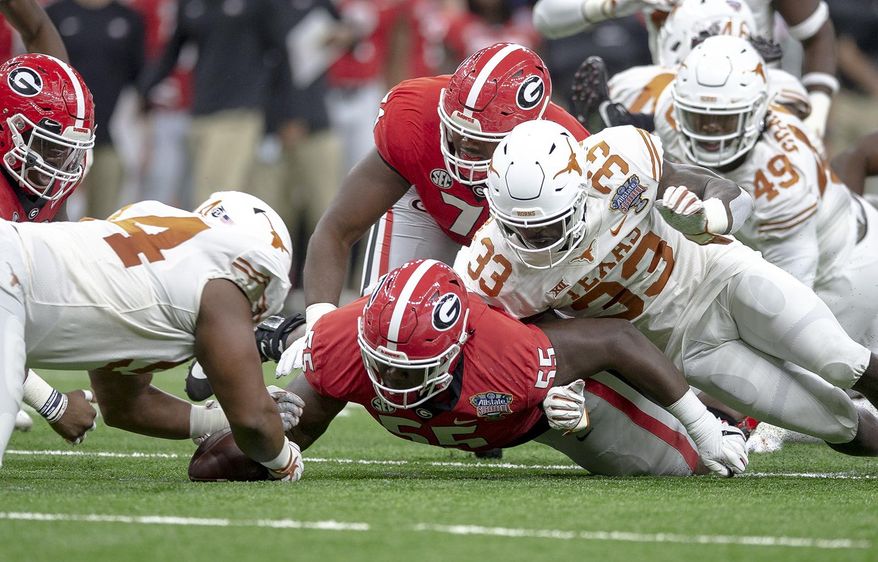 Texas defensive lineman Gerald Wilbon (94) recovers a fumble by Georgia running back D'Andre Swift during the first half of the Sugar Bowl NCAA college football game Tuesday, Jan. 1, 2019, in New Orleans. (Nick Wagner/Austin American-Statesman via AP)
