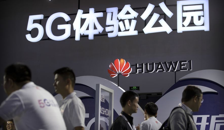 Visitors look at a display for 5G wireless technology from Chinese technology firm Huawei at the PT Expo in Beijing, Wednesday, Sept. 26, 2018. The government-organized event comes amid a mounting tariff war with Washington over Beijing&#39;s plans for the state-led creation of its own global technology competitors. (AP Photo/Mark Schiefelbein)