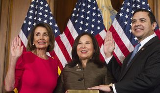 House Speaker Nancy Pelosi of Calif., right, poses during a ceremonial swearing-in with Rep. Henry Cuellar, D-Texas, right, on Capitol Hill in Washington, Thursday, Jan. 3, 2019, during the opening session of the 116th Congress. Washington, Thursday, Jan. 3, 2019. (AP Photo/Cliff Owen)