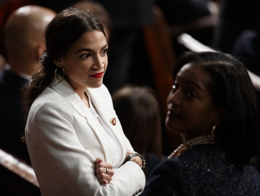Rep. Alexandria Ocasio-Cortez, D-N.Y, and Rep. Jahana Hayes, D-Conn., stand together on the House floor at the U.S. Capitol in Washington, Thursday, Jan. 3, 2019, on the first day of the 116th Congress with Democrats holding the majority. (AP Photo/Carolyn Kaster)