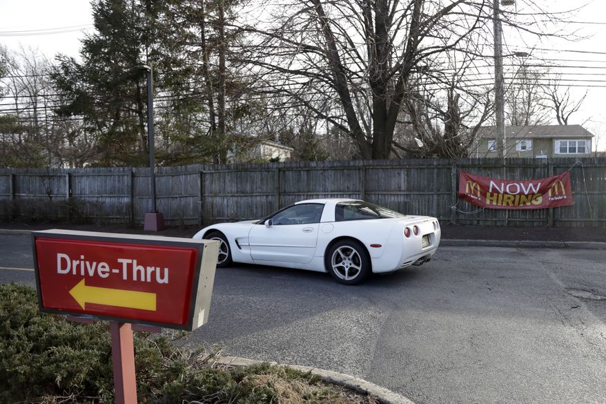 A vehicle cruises by a drive-thru and an employment sign at a McDonald's restaurant, Thursday, Jan. 3, 2019, in Atlantic Highlands, N.J. (AP Photo/Julio Cortez) **FILE**