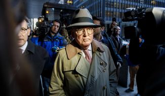 Alderman Ed Burke, 75, walks out of the Dirksen Federal Courthouse following his release after turning himself in, Thursday, Jan. 3, 2019, in Chicago. Burke, one of the most powerful City Council members in Chicago, is charged with one count of attempted extortion in trying to shake down a fast-food restaurant seeking city remodeling permits, according to a federal complaint unsealed Thursday. (Brian Cassella/Chicago Tribune via AP)