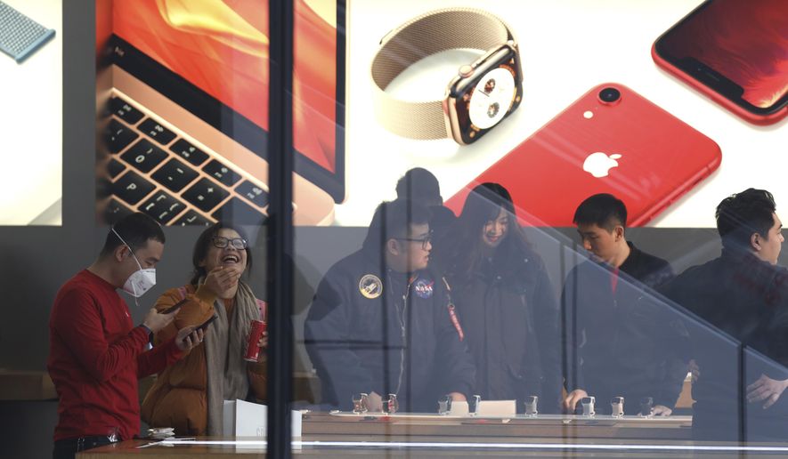 Customers visit an Apple store in Beijing, China, Thursday, Jan. 3, 2019. Apple Inc.’s $1,000 iPhone is a tough sell to Chinese consumers who are jittery over an economic slump and a trade war with Washington. The tech giant became the latest global company to collide with Chinese consumer anxiety when CEO Tim Cook said iPhone demand is waning, due mostly to China. Weak consumer demand in the world’s second-largest economy is a blow to industries from autos to designer clothing that are counting on China to drive revenue growth. (AP Photo/Ng Han Guan)