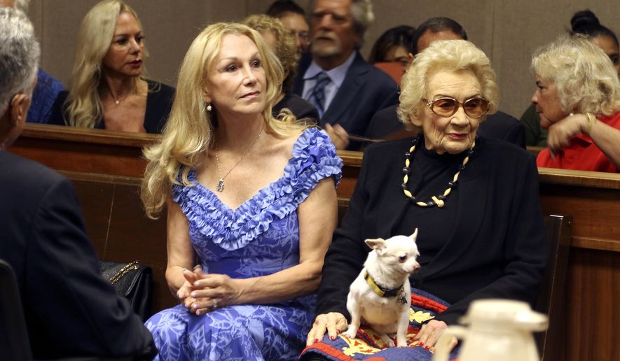 FILE - In the Sept. 10, 2018, file photo, Abigail Kawananakoa, right, and her wife, Veronica Gail Worth, appear in state court in Honolulu. The Hawaii Attorney General is opposing a change that Kawananakoa, the 92-year-old Native Hawaiian princess, has made to her trust to ensure her wife receives $40 million and all her personal property. (AP Photo/Jennifer Sinco Kelleher, file)