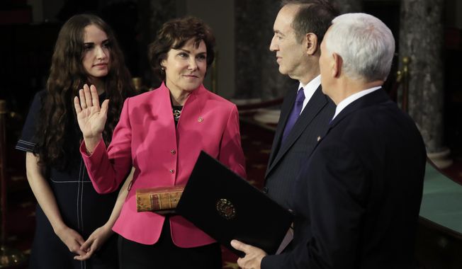 Vice President Mike Pence administers a ceremonial Senate oath during a mock swearing-in ceremony to Sen. Jacky Rosen, D-Nev., accompanied by her family Thursday, Jan. 3, 2019, in the Old Senate Chamber on Capitol Hill in Washington. (AP Photo/Manuel Balce Ceneta)