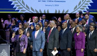 Members of the Congressional Black Caucus raise their hands during the swearing-in ceremony of CBC members at The Warner Theatre in Washington, Thursday, Jan. 3, 2019. (AP Photo/Jose Luis Magana) ** FILE **