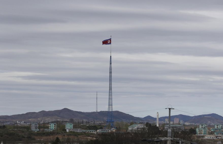 FILE - In this April 27, 2018, file photo, a North Korean flag flutters in the wind atop a 160-meter tower in North Korea's village Gijungdongseen, as seen from the Taesungdong freedom village inside the demilitarized zone in Paju, South Korea. South Korea's spy agency on Thursday, Jan. 3, 2019, has told lawmakers that North Korea's acting ambassador to Italy Jo Song Gil went into hiding with his wife in November. (AP Photo/Lee Jin-man, File)
