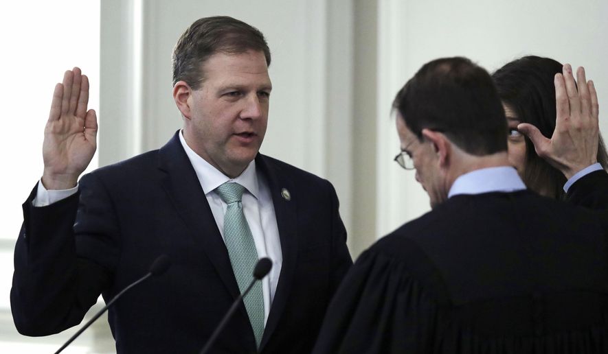 N.H. Republican Gov. Chris Sununu, left, raises his hand as he takes the oath of office from Chief Justice of the New Hampshire Supreme Court Robert J. Lynn, right, during his inauguration ceremony at the State House in Concord, N.H., Thursday, Jan. 3, 2019. Sununu begins his second, two-year term facing a Legislature controlled by Democrats. (AP Photo/Charles Krupa) **FILE**