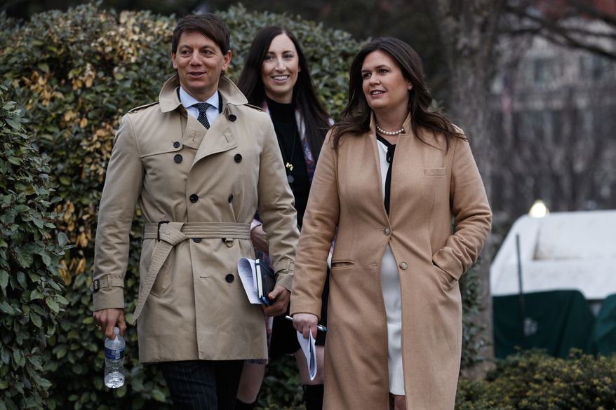 White House press secretary Sarah Huckabee Sanders walks with deputy press secretary Hogan Gidley to speak with reporters about the government shutdown outside the White House, Friday, Jan. 4, 2019, in Washington. (AP Photo/Evan Vucci)