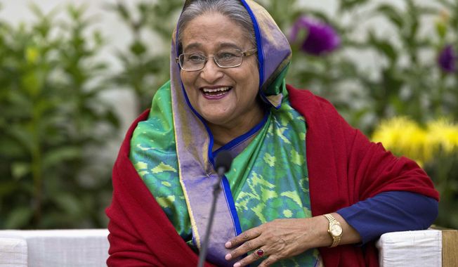 FILE - In this Monday, Dec. 31, 2018, file photo, Bangladeshi Prime Minister Sheikh Hasina interacts with journalists in Dhaka, Bangladesh. Hasina is set to begin a third straight term as Bangladesh&#x27;s prime minister after a landslide election victory, but critics fear her coalition&#x27;s dominance in Parliament leaves space for her to be more authoritarian.  (AP Photo/Anupam Nath, File)