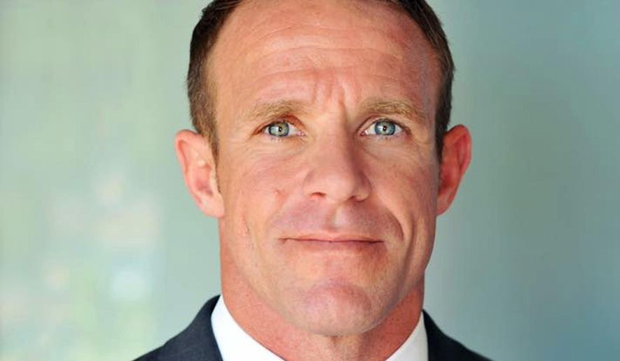 This 2018 photo provided by Andrea Gallagher shows her husband, Navy SEAL Edward Gallagher. The decorated Navy SEAL is facing charges of premediated murder and other offenses in connection with the fatal stabbing of a teenage Islamic State prisoner under his care in Iraq in 2017 and the shooting of unarmed Iraqi civilians. His attorney says he will plead not guilty to all the charges at a Naval hearing Friday, Jan. 4, 2019, in San Diego. (Andrea Gallagher via AP)