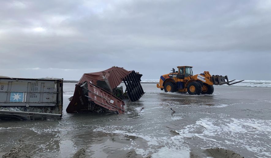 Cargo containers are removed from a beach in Vlieland, Netherlands, Friday Jan. 4, 2019, after 270 shipping containers were lost at sea by a cargo ship caught in a storm. Authorities in Germany and the Netherlands were searching for up to 270 shipping containers lost at sea by a cargo ship caught in a storm, saying that a few of them are carrying hazardous material. (Marjet van Veelen via AP)