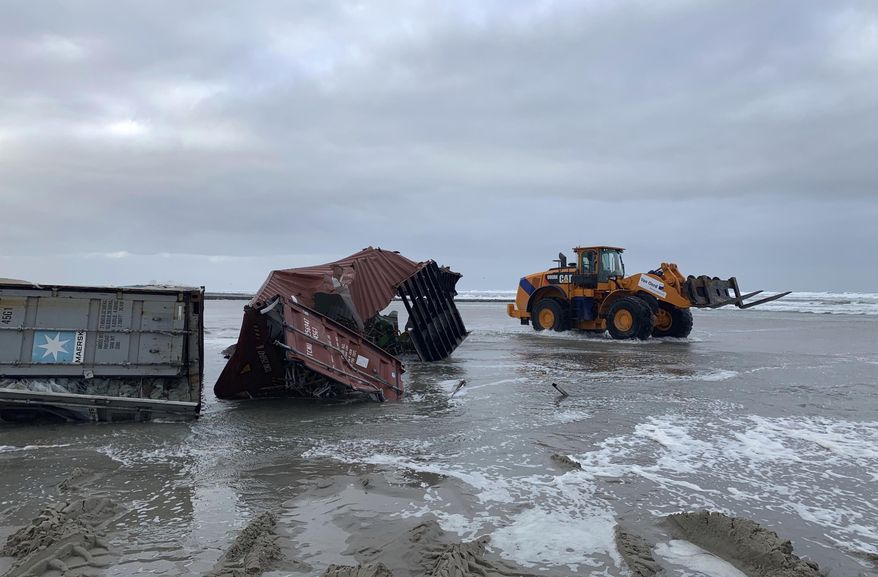 Cargo containers are removed from a beach in Vlieland, Netherlands, Friday Jan. 4, 2019, after 270 shipping containers were lost at sea by a cargo ship caught in a storm. Authorities in Germany and the Netherlands were searching for up to 270 shipping containers lost at sea by a cargo ship caught in a storm, saying that a few of them are carrying hazardous material. (Marjet van Veelen via AP)