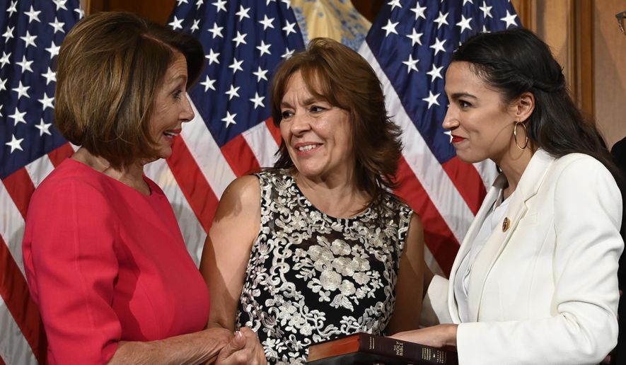 House Speaker Nancy Pelosi of Calif., left, talks with Rep. Alexandria Ocasio-Cortez, D-N.Y., right, and her mother Blanca Ocasio-Cortez, center, during a ceremonial swearing-in on Capitol Hill in Washington, Thursday, Jan. 3, 2019, during the opening session of the 116th Congress. (AP Photo/Susan Walsh) ** FILE **