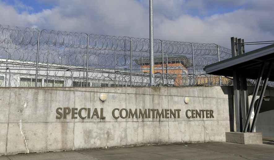 FILE - This Oct. 20, 2015, file photo, shows the main entrance to Washington state's Special Commitment Center next to a fence lined with razor wire on McNeil Island, Wash. State officials say a sexually violent predator being held at the Special Commitment Center died after suffering a head injury during a fight with another resident. Chris Wright, with the Department of Social and Health Services, said Friday, Jan. 4, 2019, 63-year-old Jerry Spicer suffered a head injury during the fight on Thursday in the facility's cafeteria. (AP Photo/Ted S. Warren, File)