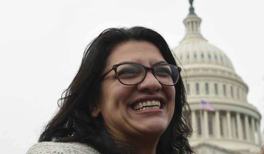 Rep. Rashida Tlaib, D-Mich., smiles following a group photo with the women in the House of Representatives on Capitol Hill in Washington, Friday, Jan. 4, 2019, during the opening session of the 116th Congress. (AP Photo/Susan Walsh)