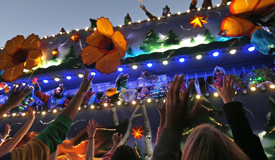 FILE - In this Feb. 25, 2017 file photo, revelers scream for beads during the Krewe of Endymion Mardi Gras parade in New Orleans. The rest of America may be winding down from Christmas and New Year’s. But in New Orleans, another party is about to get started. Mardi Gras season kicks off Sunday, Jan. 6, 2019. (AP Photo/Gerald Herbert, File)