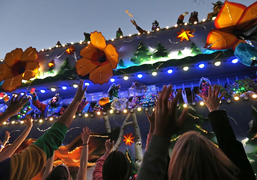 FILE - In this Feb. 25, 2017 file photo, revelers scream for beads during the Krewe of Endymion Mardi Gras parade in New Orleans. The rest of America may be winding down from Christmas and New Year’s. But in New Orleans, another party is about to get started. Mardi Gras season kicks off Sunday, Jan. 6, 2019. (AP Photo/Gerald Herbert, File)