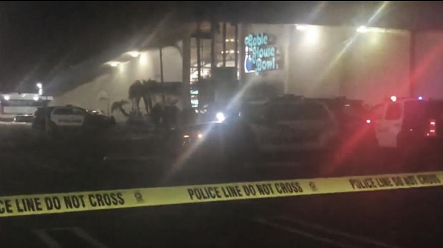 Police rope off the scene of a shooting at a bowling alley in Torrance, Calif., early Saturday, Jan. 5, 2019. The Torrance Police Department responded to calls of "shots fired" at the Gable House Bowl shortly before midnight, Friday.Multiple victims were found with gunshot wounds inside the bowling ally, which is described on its website as a gaming venue that offers bowling, laser tag and a full arcade. (AP Photo/APTN)