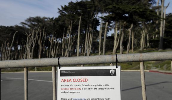 A sign is posted on a gate blocking a parking lot to Land&#39;s End in San Francisco, Thursday, Jan. 3, 2019. Nonprofits, businesses and state governments across the country are paying bills and putting in volunteer hours in an uphill battle to keep national parks safe and clean for visitors as the partial U.S. government shutdown lingers. (AP Photo/Jeff Chiu)