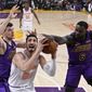 New York Knicks center Enes Kanter, center, tries to shoot as Los Angeles Lakers center Ivica Zubac, left, and guard Lance Stephenson defend during the first half of an NBA basketball game Friday, Jan. 4, 2019, in Los Angeles. (AP Photo/Mark J. Terrill)