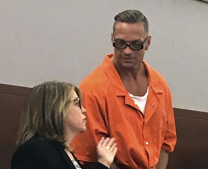 FILE - In this Aug. 17, 2017, file photo, Nevada death row inmate Scott Raymond Dozier, right, confers with Lori Teicher, a federal public defender involved in his case, during an appearance in Clark County District Court in Las Vegas. Authorities say the 48-year-old Nevada death-row inmate who wanted for two years to die, but whose execution was postponed twice, has been found dead in his cell on Saturday, Jan. 5, 2019, from an apparent hanging. (AP Photo/Ken Ritter, File)