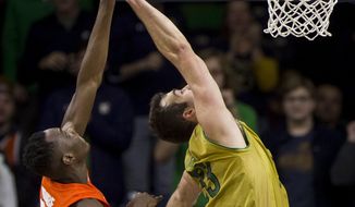 Syracuse&#x27;s Bourama Sidibe (34) and Notre Dame&#x27;s John Mooney (33) compete for a rebound during the second half of an NCAA college basketball game Saturday, Jan. 5, 2019, in South Bend, Ind. Syracuse won 72-62. (AP Photo/Robert Franklin)