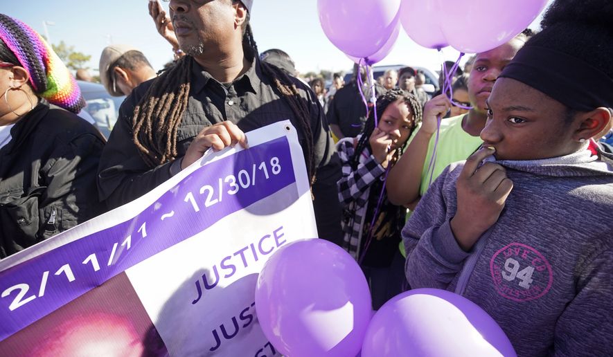 Zyriah Taylor, 11, center left, and her cousins, Jaskya Lee-Mills, 13, and Aarika Lee, 12, right, attend a community rally outside a Walmart on East Sam Houston Pkwy N in Houston on Saturday, Jan. 5, 2019 for 7-year-old Jazmine Barnes, who was killed on Sunday. Jazmine was shot to death nearby while riding in a car with her mother and three sisters. (Melissa Phillip/Houston Chronicle via AP)