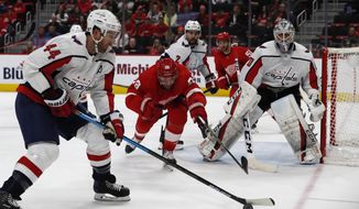 Washington Capitals defenseman Brooks Orpik (44) controls the puck as Detroit Red Wings left wing Thomas Vanek (26) reaches in during the third period of an NHL hockey game, Sunday, Jan. 6, 2019, in Detroit. (AP Photo/Carlos Osorio) ** FILE **