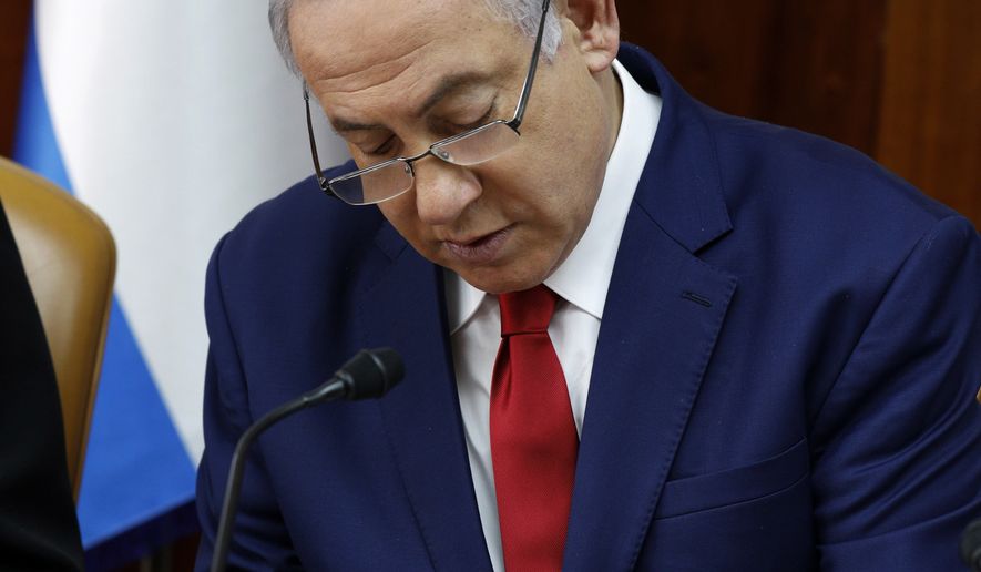 Israeli Prime Minister Benjamin Netanyahu prepares his statement at the start of the weekly cabinet meeting at the prime minister&#x27;s office in Jerusalem, Sunday, Jan. 6, 2019. (Gali Tibbon/Pool via AP)